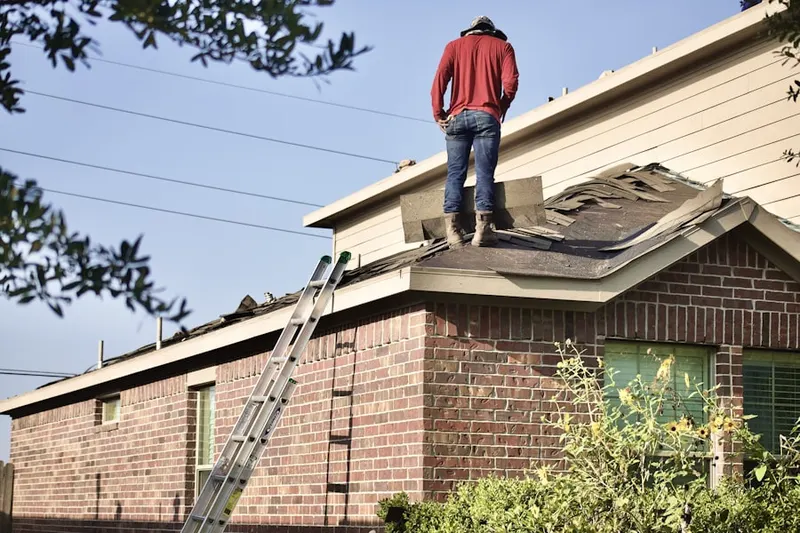 Professional roofer working on a residential roof in Progress Village